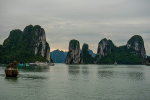 Placid waters of Ha Long Bay with a fishing village at the base of an island