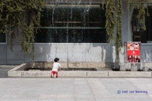 Boy Playing by Waterfall Pool in Tenjin Park