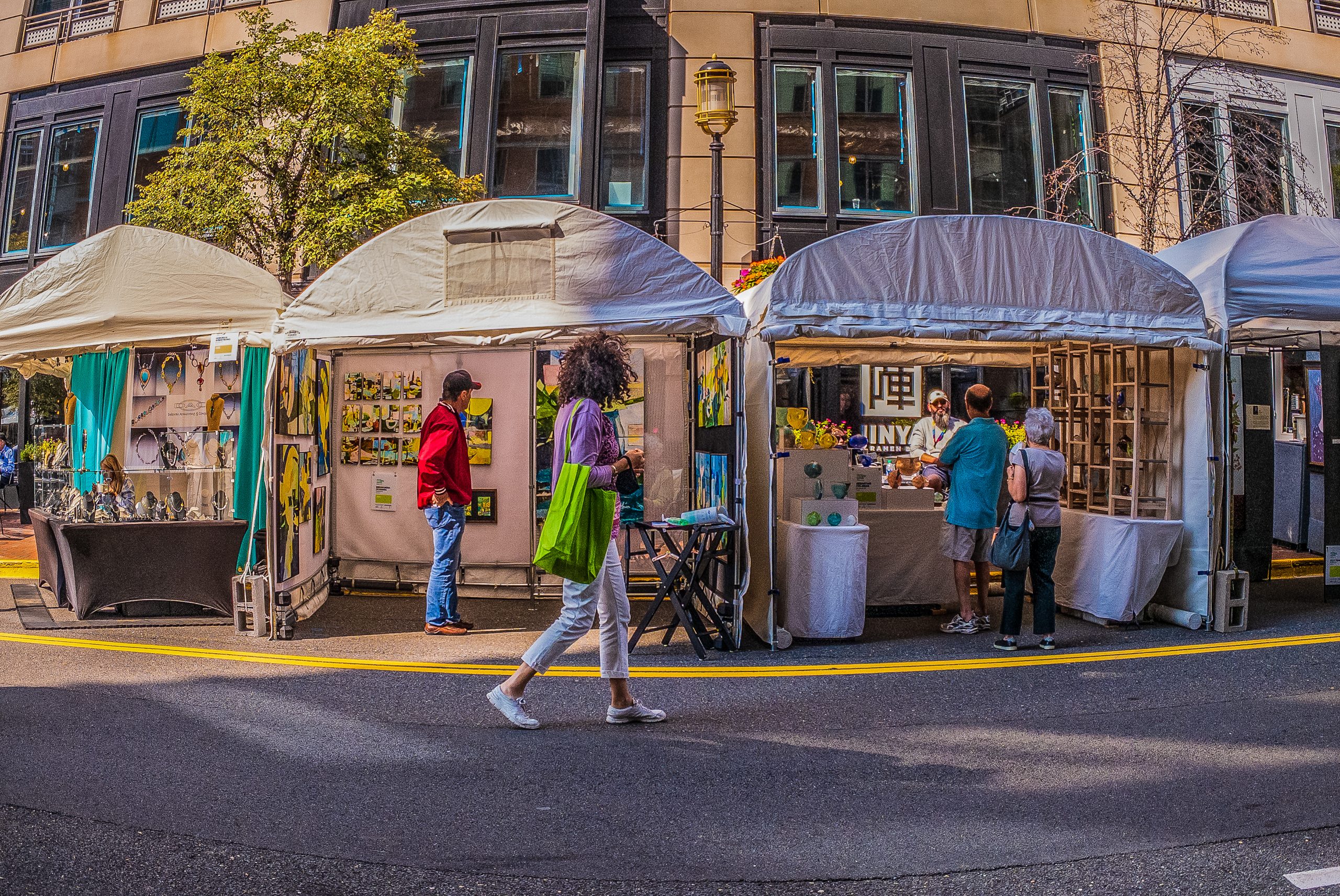 Reston, VA, USA -- Sept 10, 2021. A woman walks by booths set up for the annual Northern Virginia Art Festival in Reston, VA.