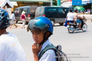 Young boy on the back of a motorbike in Cambodia