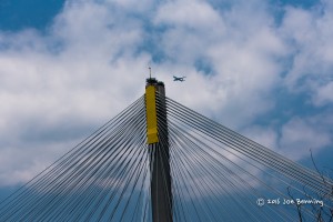 Plane flying over span bridge in Hong Kong