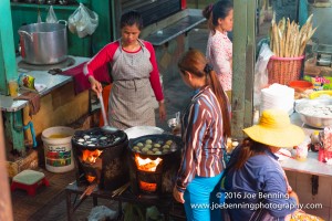 Woman cooking meals in open market in Cambodia