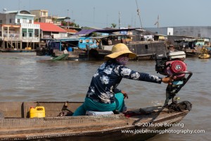 Vietnamese Woman Navigating the Mekong River