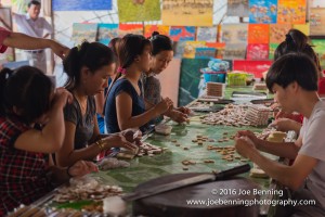Workers making coconut candy in a village workshop along the Mekong River