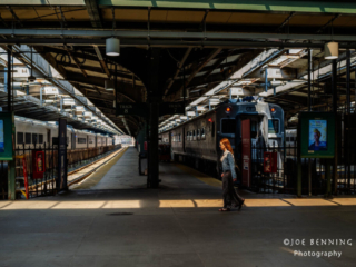 Woman Walks Through Light in Train Station 