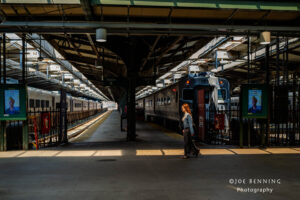 Woman Walks Through Light in Train Station 