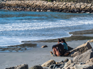 Young Couple Sitting on Beach