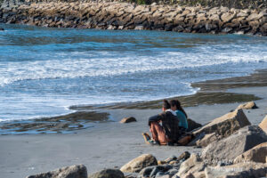 Young Couple Sitting on Beach