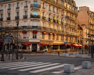 Golden morning light on a Haussmann-era corner building near Notre Dame in Paris