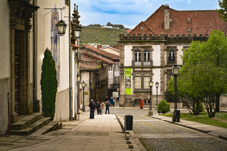 Narrow Historic Street Leading Through a Portuguese Town