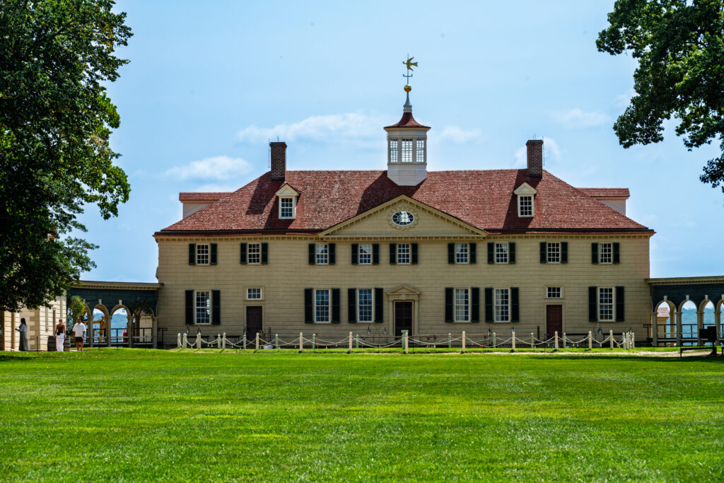 Front view of George Washington's Mount Vernon mansion with green lawn in Virginia