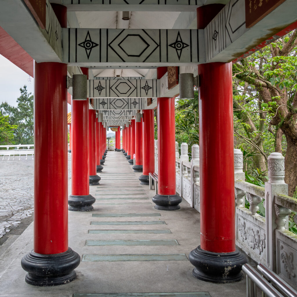 Rows of red columns frame a covered temple walkway in Taiwan.