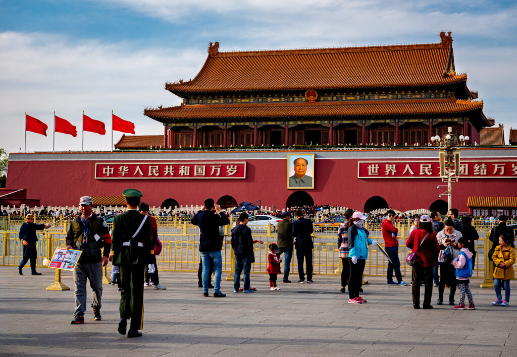 Visitors gather before Tiananmen Gate and its central portrait of Mao Zedong in Beijing, China.